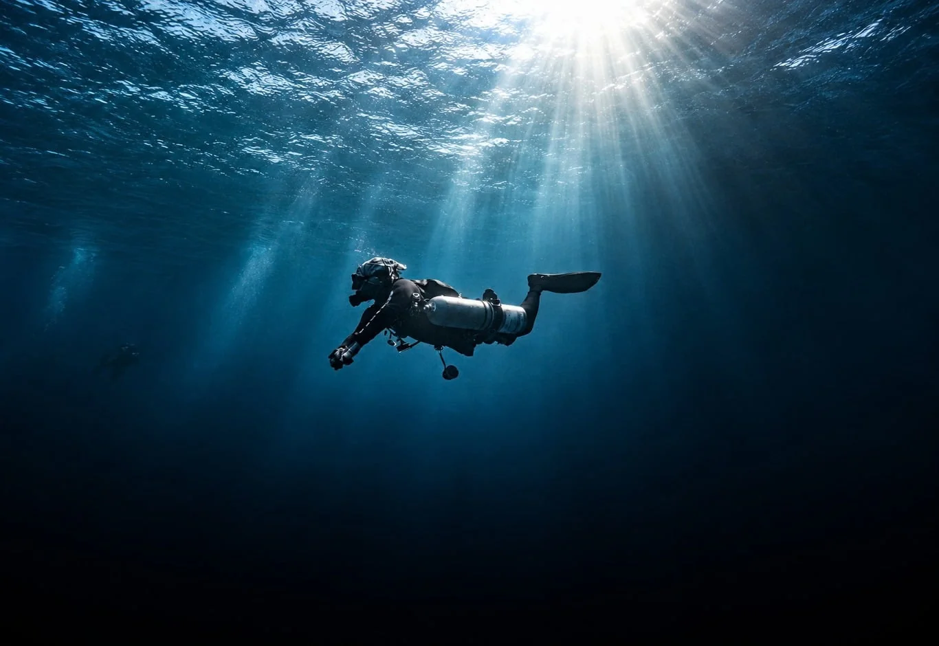 Scott Finch Sidemount diving beneath sunlight in Gran Canaria